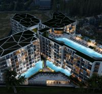 Apartment construction in Phuket: Modern complex with a pool in a nighttime setting.