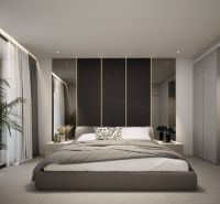 Bedroom in a 2-room apartment with a large bed and decorative lighting.