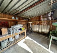 A wooden room with a metal roof and work supplies in a family house.