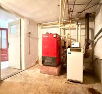 Boiler room in a family house with a boiler and water heater, basic space without decorations.