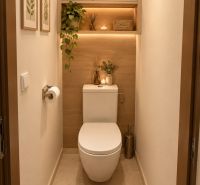 A bathroom in a 2-room apartment with decorative elements and a plant.