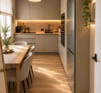 A kitchen in a 2-room apartment with a wooden decor floor and built-in appliances.