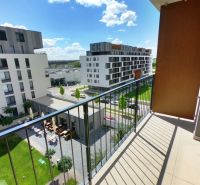 A balcony overlooking the streets of Zuzana Chalupová in Petržalka, surrounded by modern architecture.