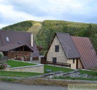A cottage in Nižná Polianka in the mountains with grassy gardens and modern architecture.