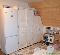 Children's corner in a cabin with wood-patterned flooring and storage space.