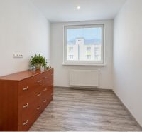 A bright room with a drawer chest and wood-patterned flooring in a 4-room apartment.