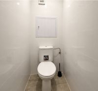 A bathroom with light walls and tiles in a 4-room apartment.