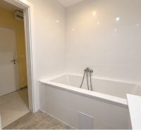 A bathroom with a fresh bathtub and white tiles, 4-room apartment.