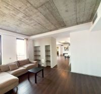 Living room in a 4-room apartment with a wooden decor floor and a sofa.