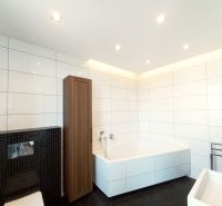 A bathroom with a shower, bathtub, and wooden decor in a 4-room apartment.