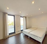 A bedroom with a bed and a wooden decor floor in a 4-room apartment.