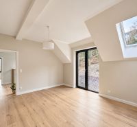 A bright room in a family house with a French window and a floor with a wooden decor.