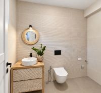 A bathroom with wooden decor, a sink, and a mirror in a family house.
