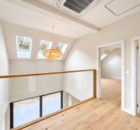 Attic space with glass railing and wooden decor flooring, family house.