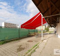 Terrace with a red awning at commercial premises on Korytnická in Bratislava - Podunajské Biskupice.