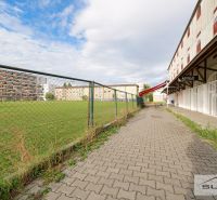 Exterior on Korytnická in Bratislava - Podunajské Biskupice, Commercial spaces with lawn and sidewalk.