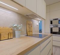 A kitchen in a 4-room apartment with an induction cooktop and ovens for baking.