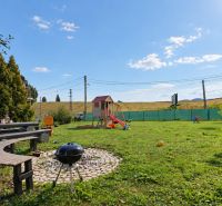 A garden with seating and a children's playground at a 4-room apartment on Bystrická Street in Rajec.