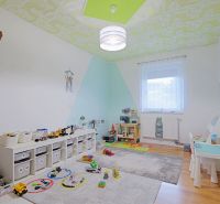 Children's room with toys and a wooden decor floor in a 4-room apartment.