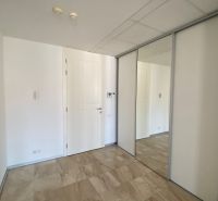 A hallway with tiles and a built-in wardrobe, suitable for a 3-room apartment on Hlboká Street.