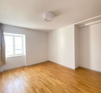 An empty room with a wooden floor and a window on Hlboká Street, a 3-room apartment.