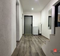 Entrance hallway in a 4-room apartment with a wood-patterned floor and a staircase.