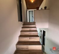 A staircase with a wooden floor and white walls in a 4-room apartment.