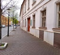Františkánska Street in Trnava with historic buildings and trees near the offices.