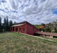 A family house on Chmeľová dolina in Zobor, surrounded by greenery and with a visible veranda.