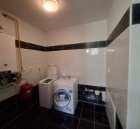 Technical room with a washing machine and boiler in a family house.