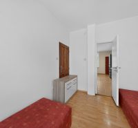 A room in a 3-room apartment with a bed and a floor with a wooden decor.