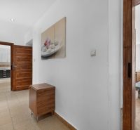 Interior of a 3-room apartment with a spacious hallway and wooden details.