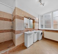 Bathroom in a 3-room apartment with tiles, sinks, and a washing machine.