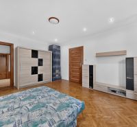 Living room in a 3-room apartment with a wooden decor floor and furniture.