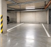 Underground parking space in garages with signaling stripes and concrete walls.
