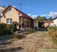 A family house in Cabov with a red roof, a front garden, and a paved walkway.