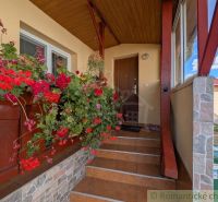 Entrance to the family house in Cabov with flowers and decorated staircase.