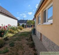 A family house in Cabov with a garden and flower beds.