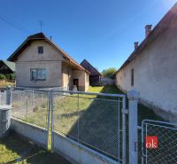 A family house in the town of Žiar with a yard, fence, and surrounding greenery.
