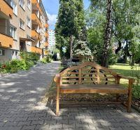Exterior of a 3-room apartment on Pred poľom Street in Trenčín with garden seating.