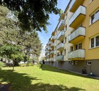 An apartment building on Pred poľom Street in Trenčín, surrounded by greenery and trees.
