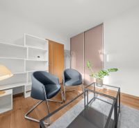 3-room apartment with wooden decor, white furniture, and a glass table.