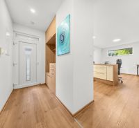 A hallway in a 3-room apartment with a wooden decor floor and built-in furniture.