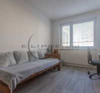 Children's room in a 3-room apartment with a sofa, desk, and toys.