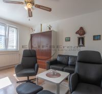 Living room with comfortable seating and wooden decor flooring in a 3-room apartment.