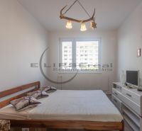A bedroom with a double bed and light furniture in a 3-room apartment.