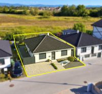 The family house on Martina Benku Street in Kostolište has a sloped roof and a landscaped garden.
