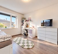Children's room with wood-decorated flooring in a family house with white furniture.