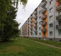 An apartment building on 28. októbra Street in Trenčín surrounded by greenery.