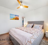 Bedroom in a family house with a bed and a wooden decor floor.